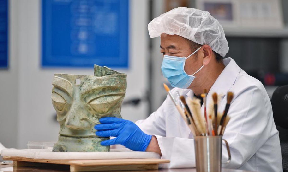 A skilled expert restores cultural relics at Sanxingdui Ruins site in SW China's Sichuan